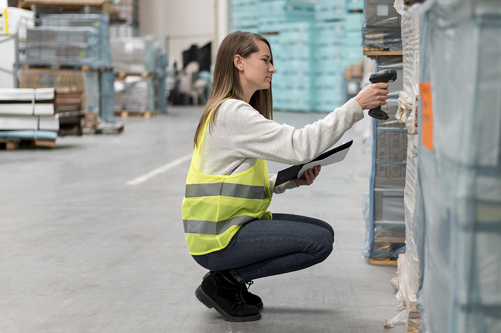 Warehouse associate scanning a packaged shipment